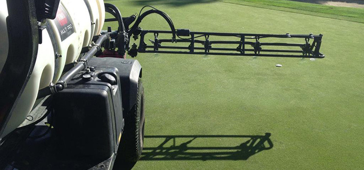 spraying fertilizer on golf course